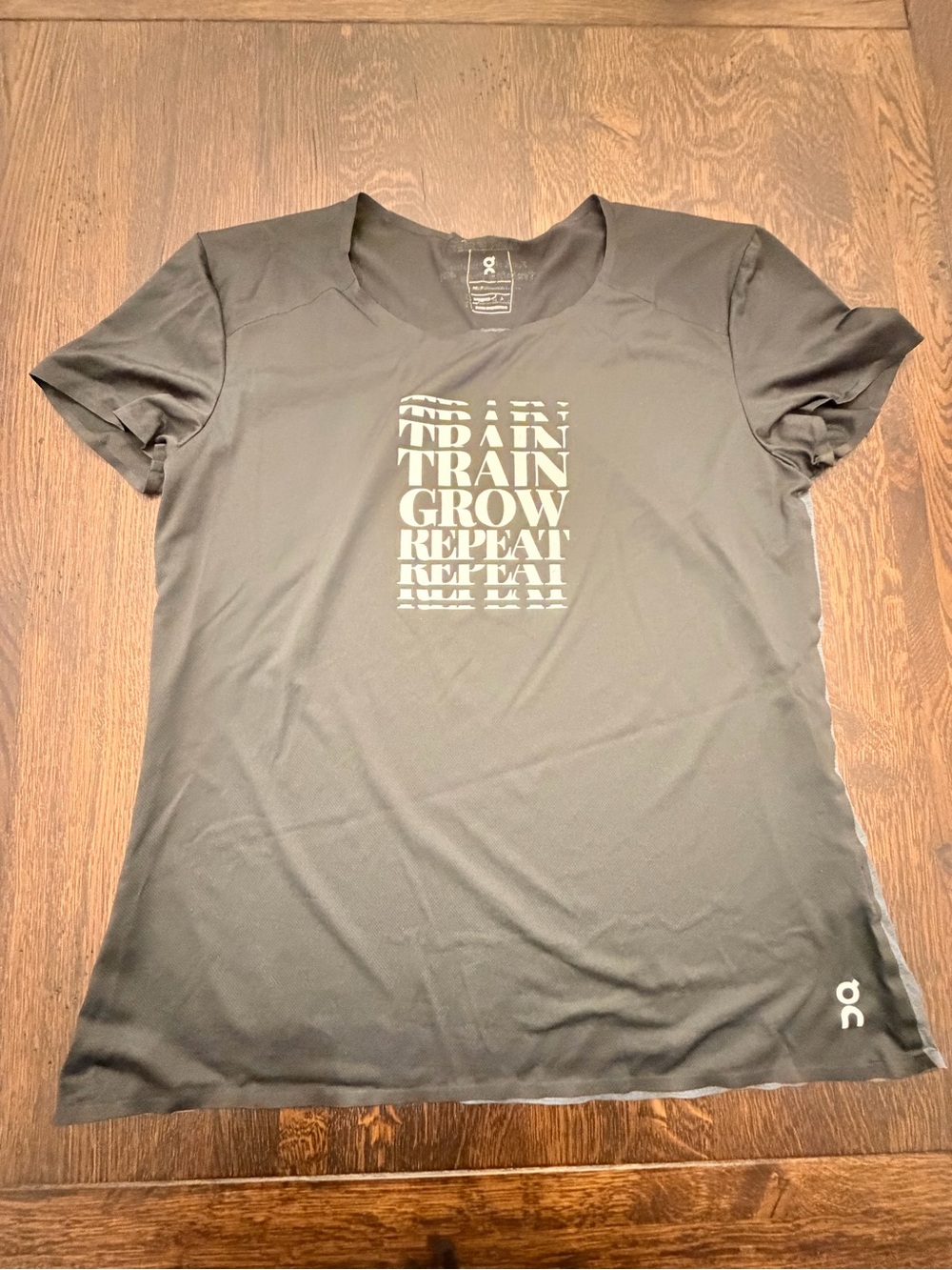 On Running Black Short-Sleeve Tee with 'Train Grow Repeat' Graphic